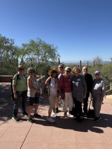 Group of adults posing on desert overlook