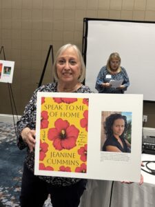 Smiling woman holding yellow floral book display