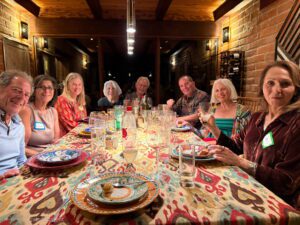 Smiling group around colorful dinner table