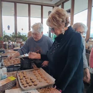 Women baking cookies together in kitchen