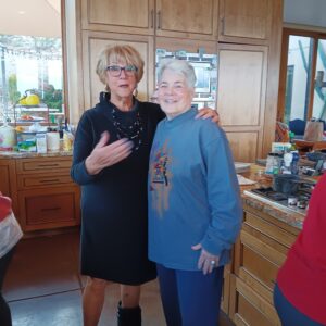 Two people smiling together in a kitchen