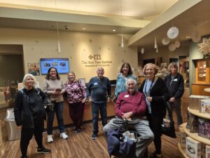 Group of people in miniature museum gift shop