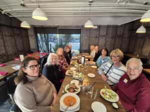 Group dining at long wooden table