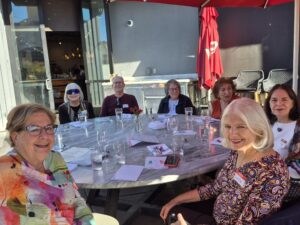 Friends gathered at outdoor cafe table