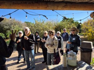 Outdoor tasting group of visitors holding drinks