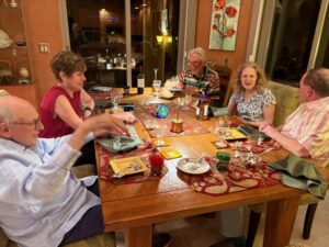 Group of people enjoying dinner around table