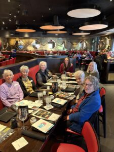 Group of women seated at long restaurant table