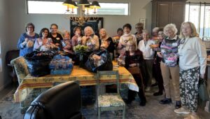 Volunteer women packing snack bags at table