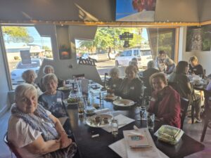 Senior women eating together at restaurant table
