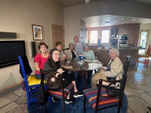 Seniors gathered around kitchen dining table