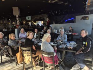 Group of women dining together in cozy restaurant