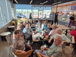 Friends enjoying coffee and pastries at cafe