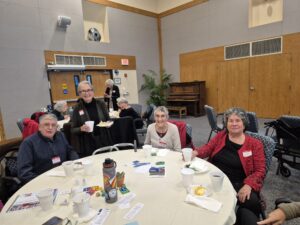 Smiling seniors around table at community center