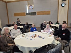 Seniors enjoying games and snacks at table