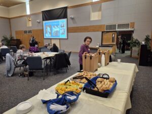 Community luncheon buffet with woman serving coffee