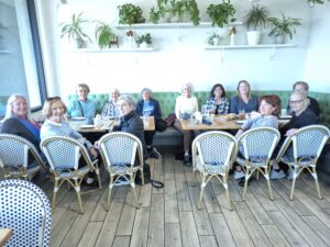Group of women chatting at plant-filled café
