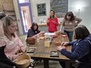 Women crafting together at community workshop table
