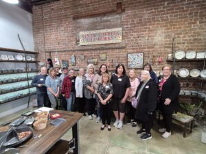Group of people in rustic tile workshop