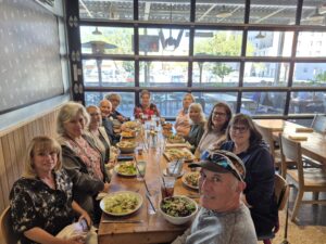 Group dining at long wooden restaurant table