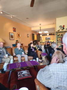 Group gathering in cozy living room with dog