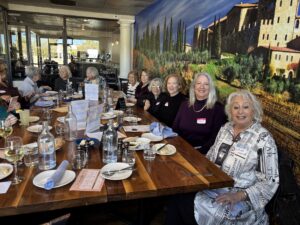 Women dining at restaurant with mural