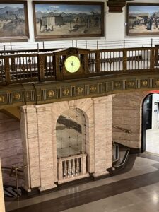 Ornate marble lobby with balcony clock