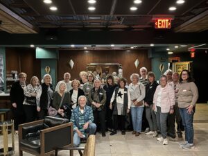 Smiling group of adults posing in hotel lobby