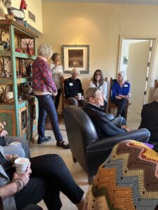 Adults chatting over coffee in cozy living room