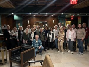 Senior friends posing together in hotel lounge