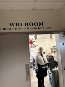 Person standing in wig room doorway