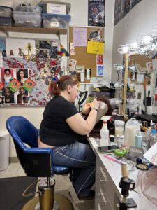 Wig artist fitting wig on mannequin head