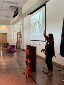 Woman presenting with projected photo and lion costume