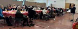 Seniors attending community presentation in hall