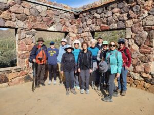 Hiking group posing inside desert stone ruins