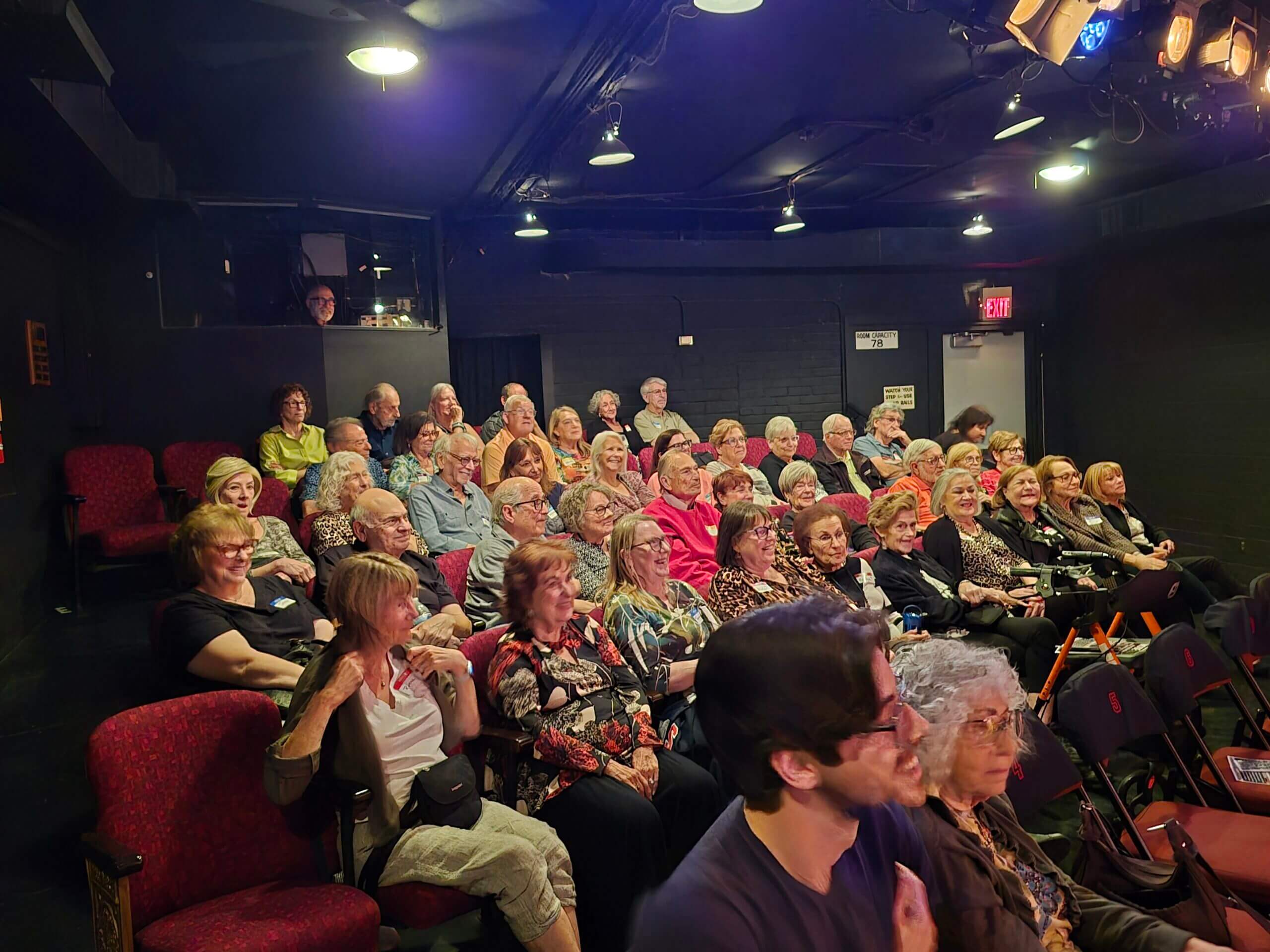 Intimate theater audience seated for performance