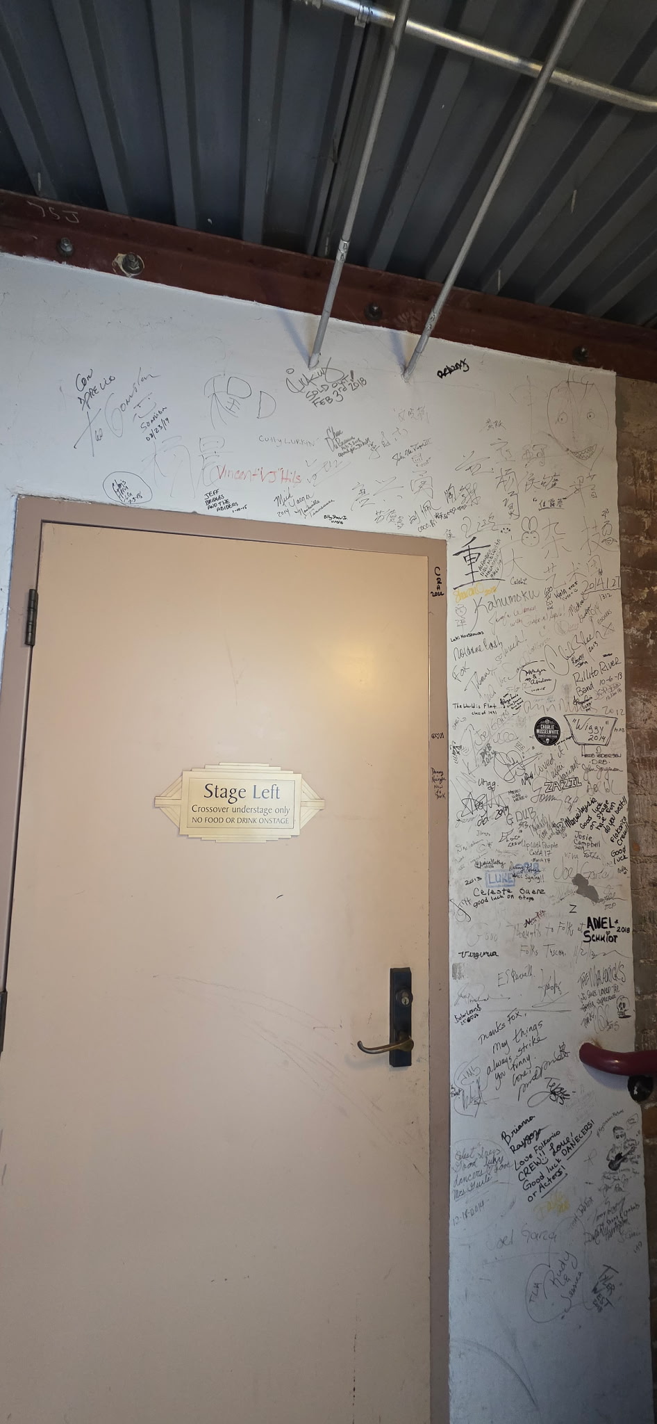 Beige door with autographed white wall