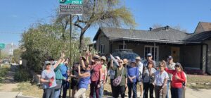 Neighborhood walking group posing by street sign