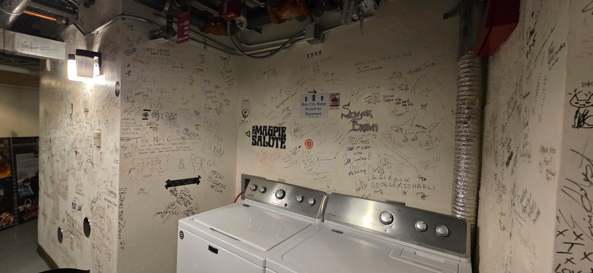 Washer and dryer in graffiti-covered laundry room