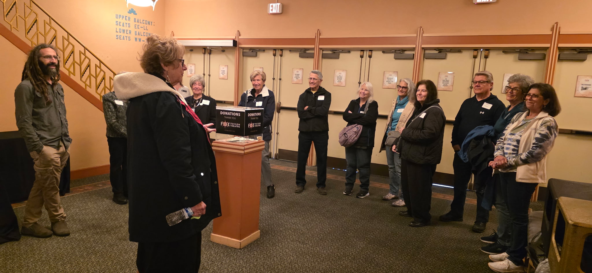 Group of visitors gathered in museum lobby