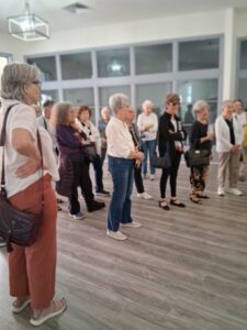 Group of older adults listening at meeting