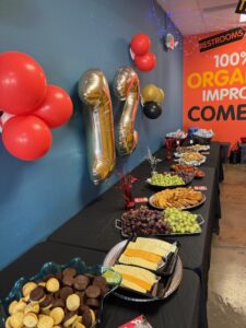 Party snack table with gold 11 balloons