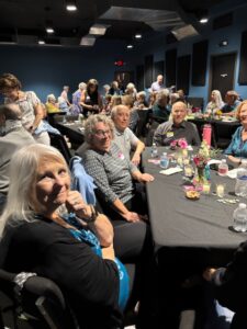 Seniors socializing at indoor banquet tables