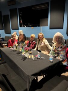 Women enjoying snacks at decorated event table