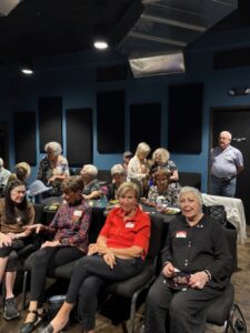 Group of seniors socializing in community room
