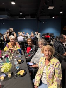 Seniors socializing around table at luncheon