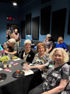 Smiling seniors seated around a decorated table