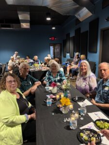 Adults seated at decorated indoor banquet table