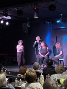 Live improv performers on small theater stage