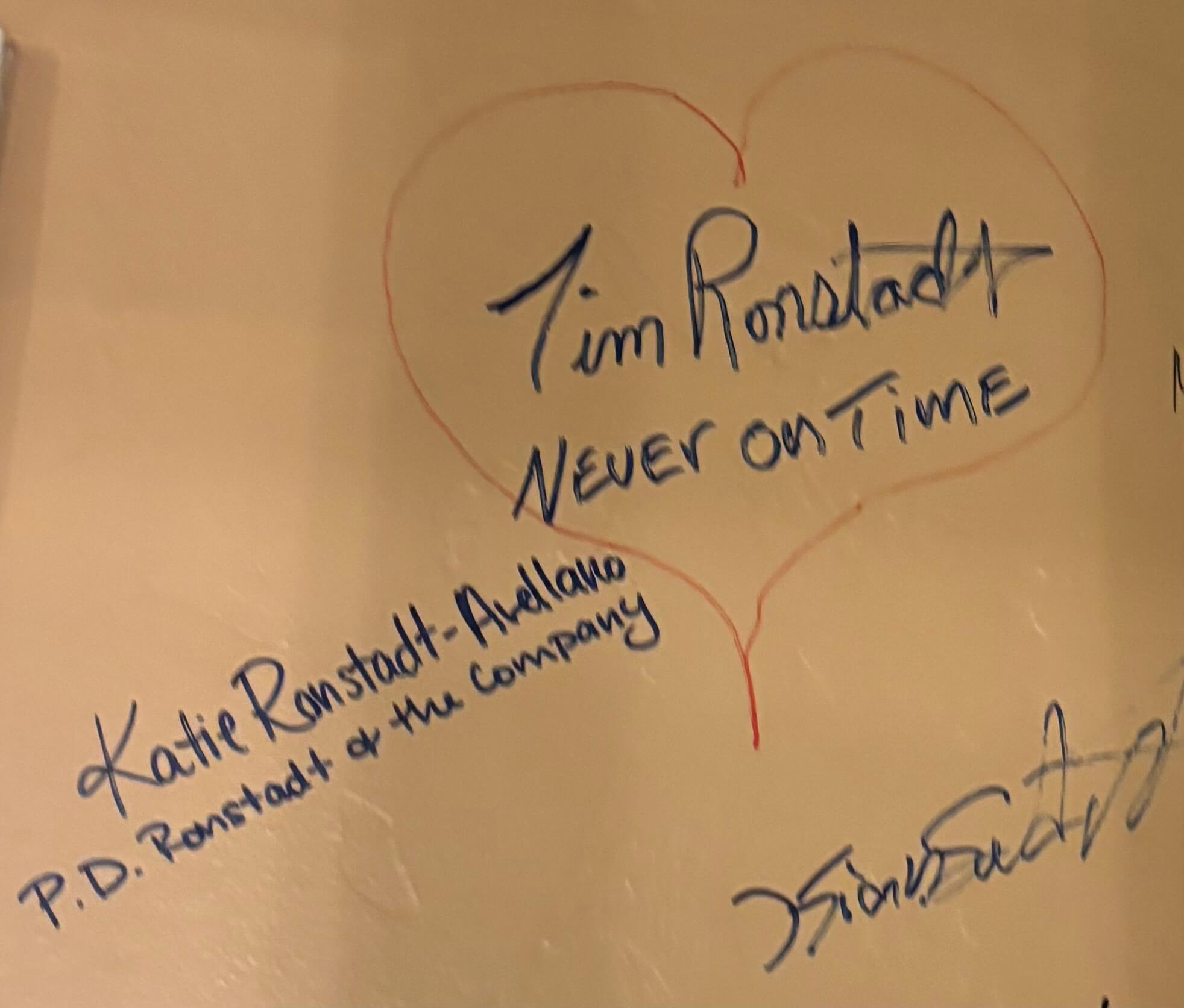 Handwritten signatures and heart doodle on paper