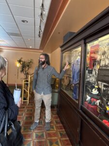 Visitor pointing at memorabilia display case